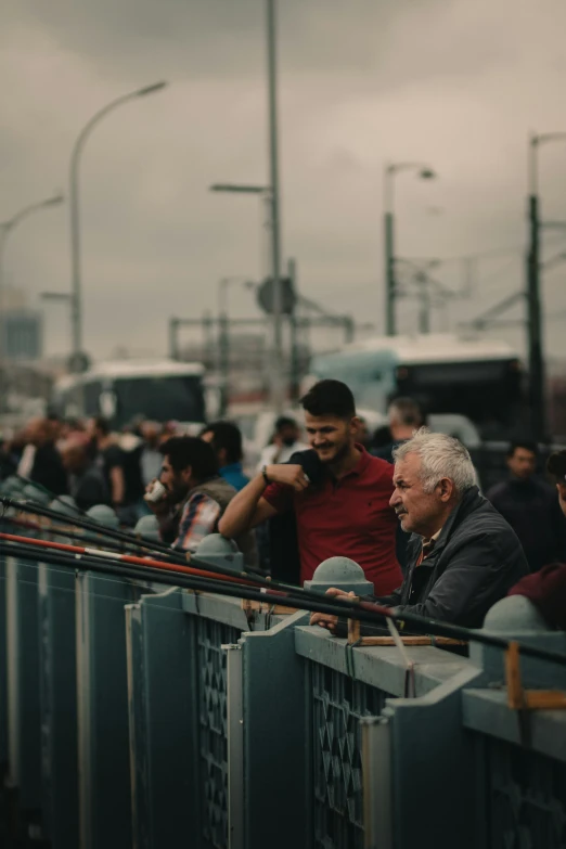 a number of people sitting and standing at the same event