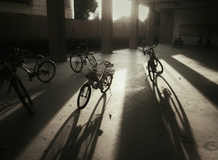 three bikes are parked inside a parking garage