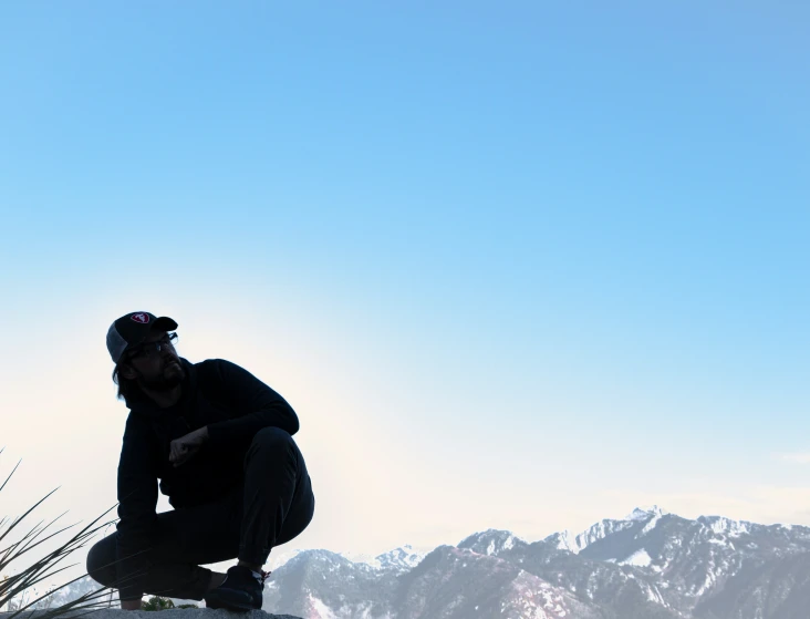 there is a man that is snowboarding and squatting