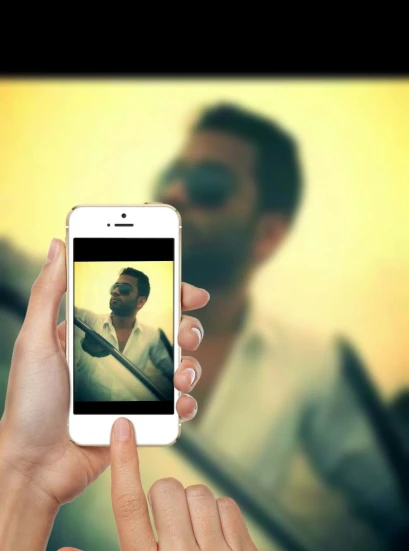 a person holding a cell phone displaying a picture