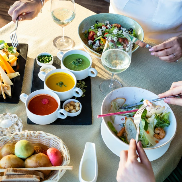 several people eating and drinking on a table