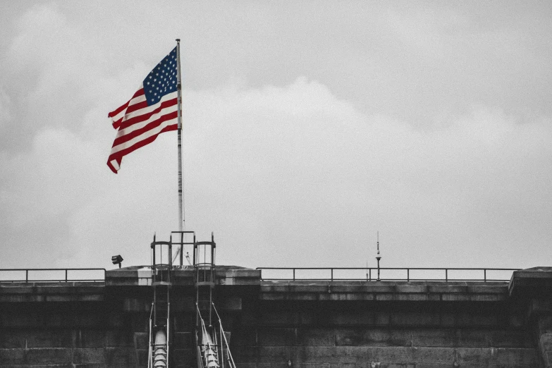 the flag is flying on top of a building