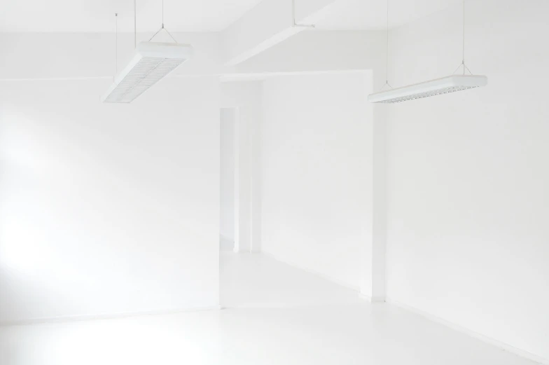 a room that has white walls with lights in it