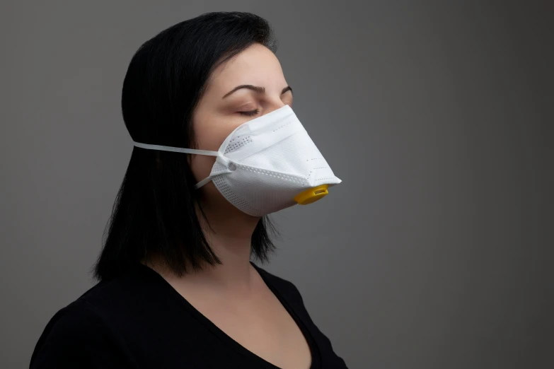 a woman in black shirt and white face mask