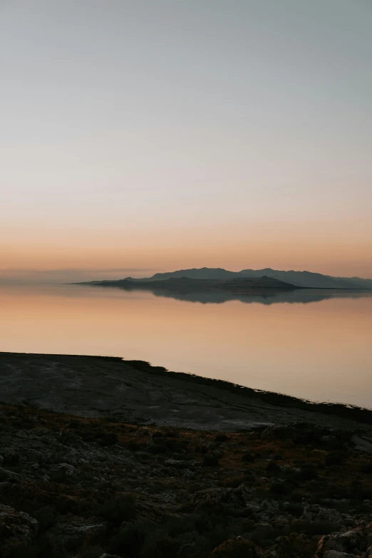 a body of water sitting under a clear sky