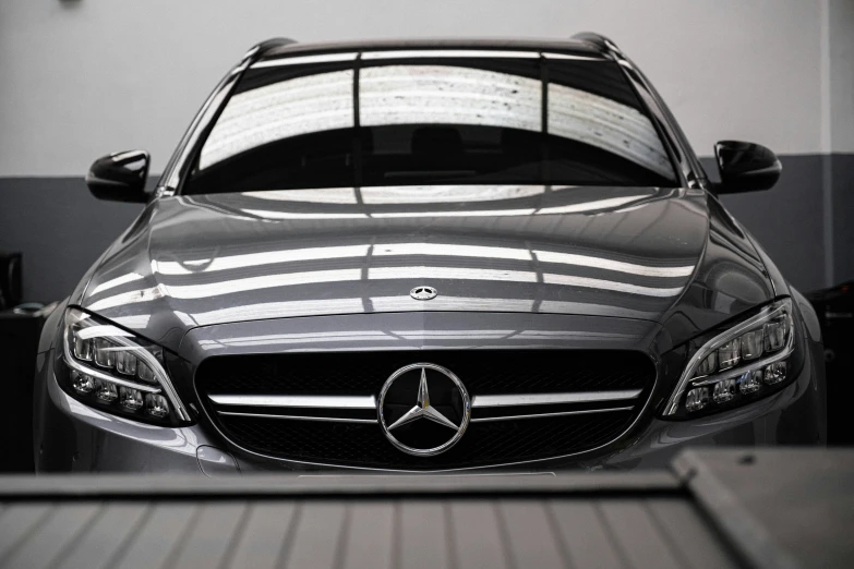 the front of a mercedes benz in an automobile showroom