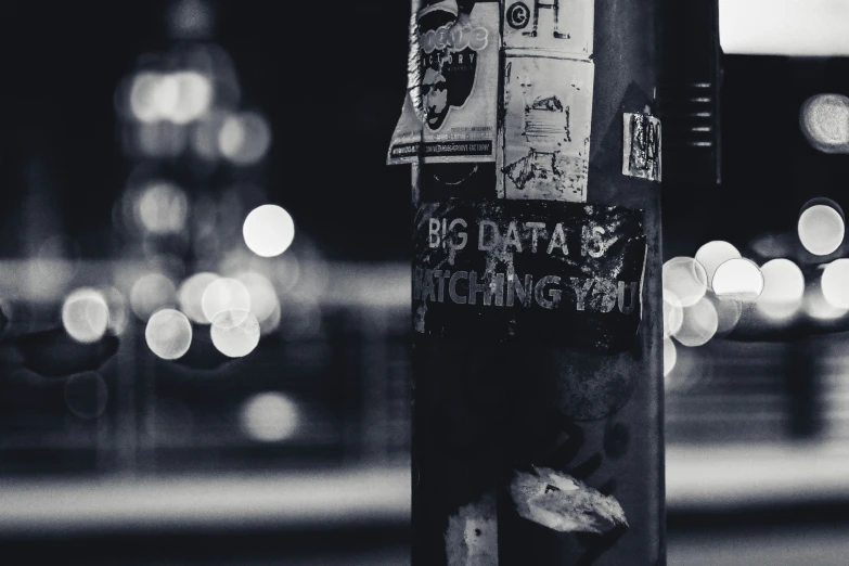 some papers stuck to the side of a pole