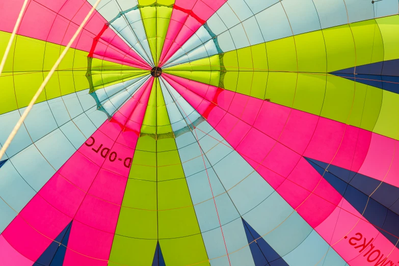 a colorful and vint  air balloon sitting on a white floor