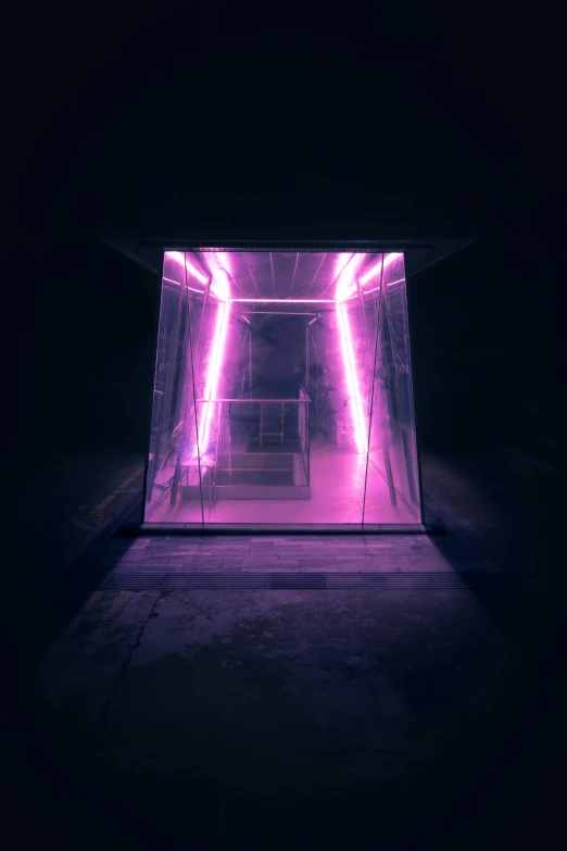 a small room in the dark with neon lights on