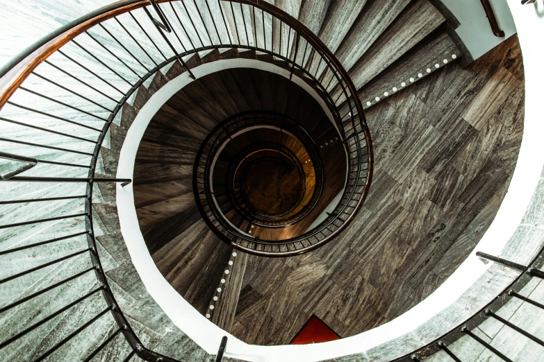 a very tall spiral staircase with a metal railing