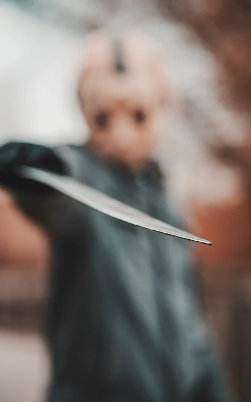 a person holds a knife with both hands