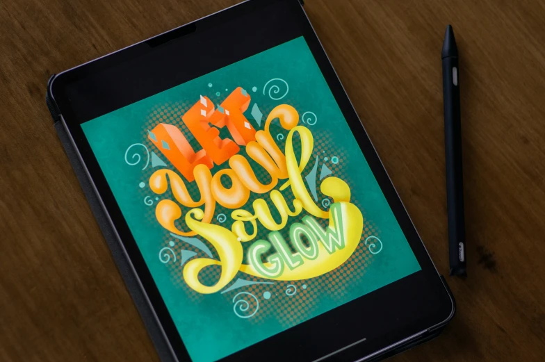 a tablet with an artistic hand lettering on it