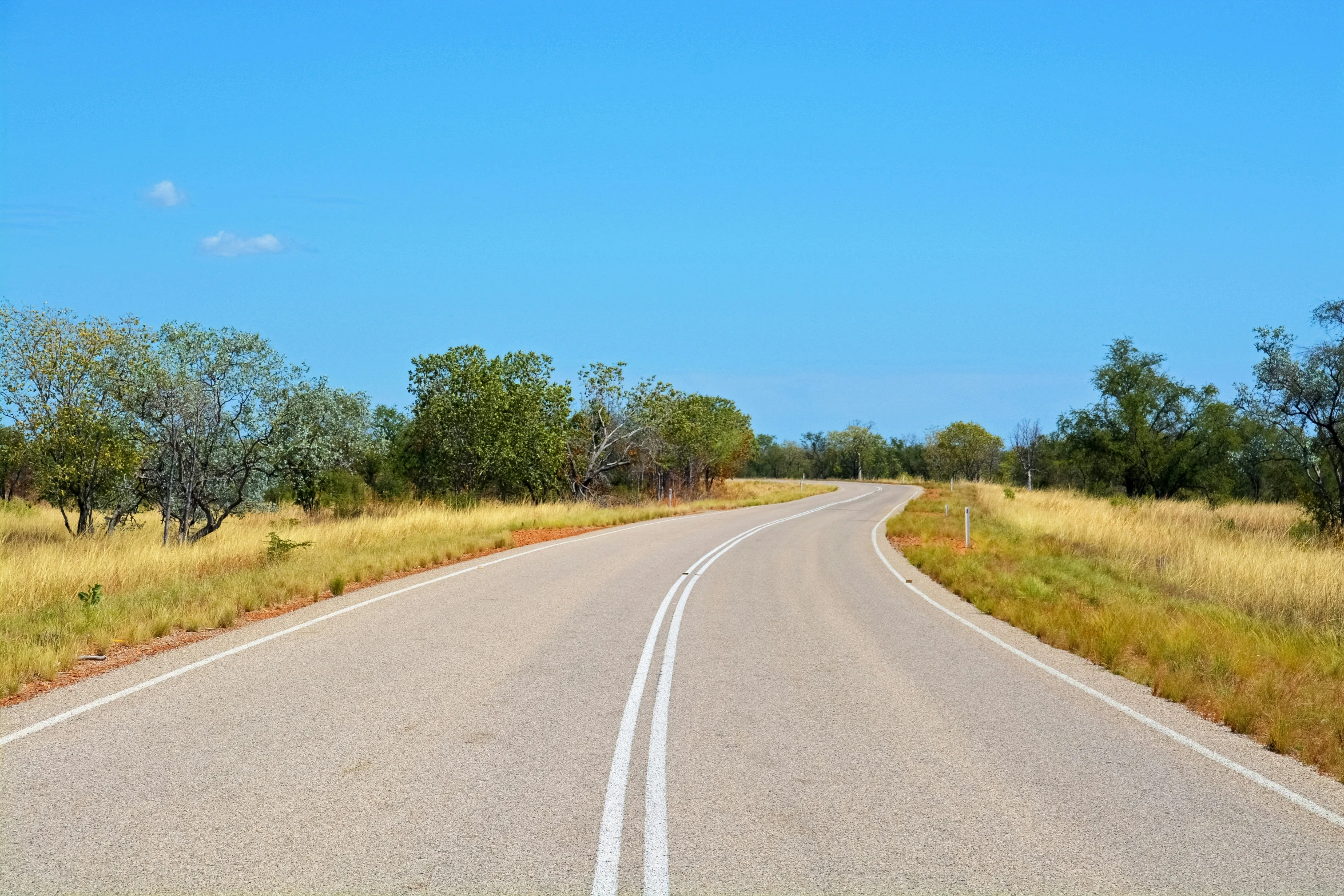 this is a long empty road in the countryside