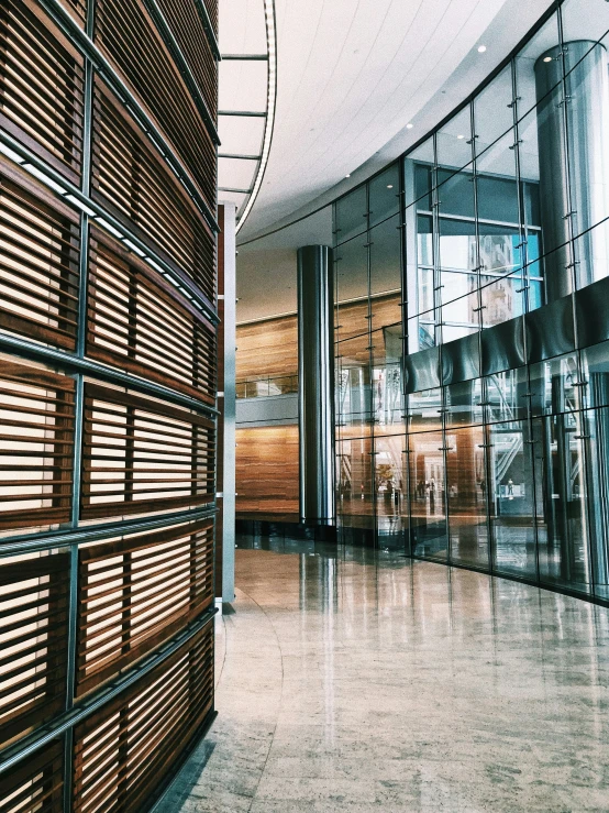 a very modern building has an oval mirror