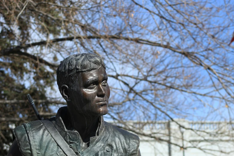 a bust of a man wearing a jacket holding a baseball bat