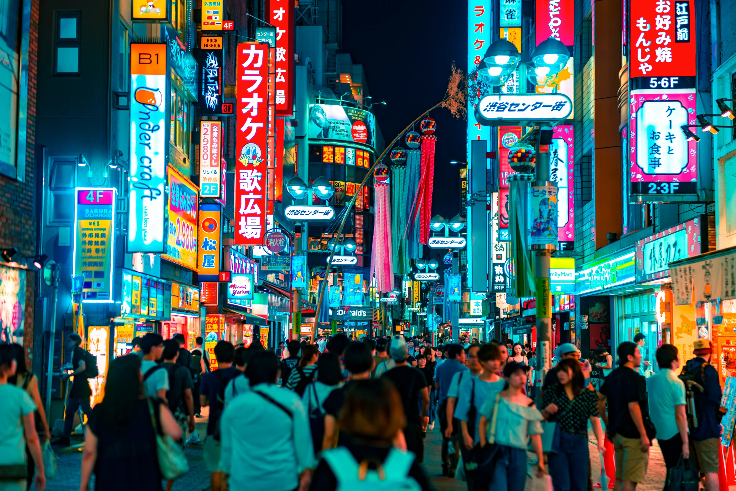 people in street near many different building in large city at night