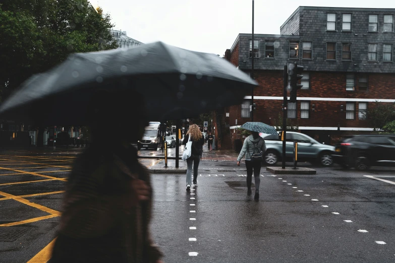 a person walking down the street with an umbrella