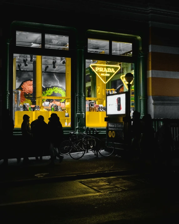 some people sitting in front of a store window