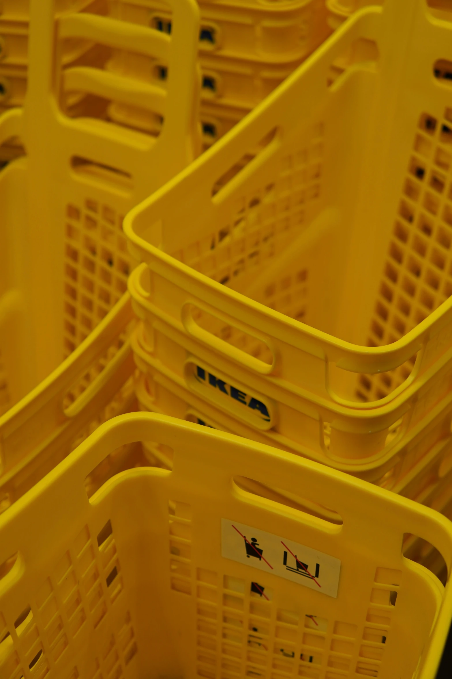 a row of yellow plastic baskets sitting on top of each other