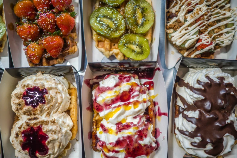 four different types of dessert in trays, with toppings