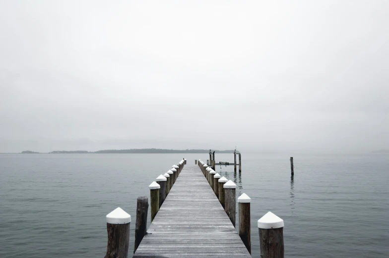 a dock has railing with white paint on it