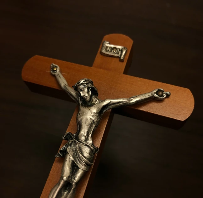 a statue of a man on a wooden cross