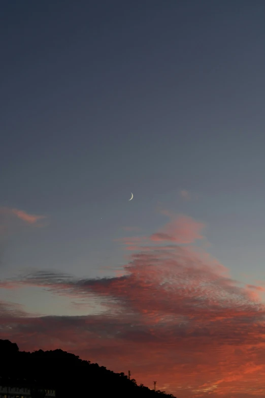 clouds at night time with a light on one cloud