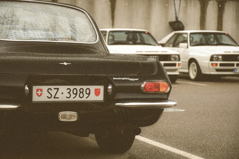 the back end of a black and white car