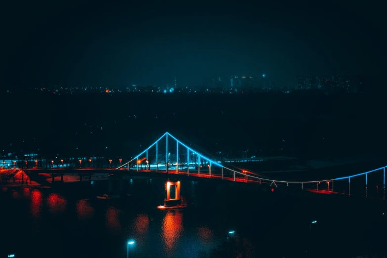 a lit up bridge over a large body of water