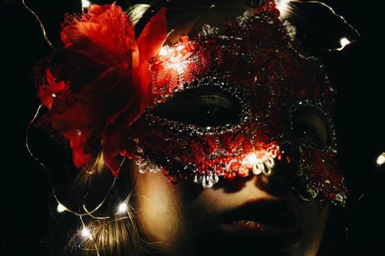 there is a woman wearing a masquerade and flowers