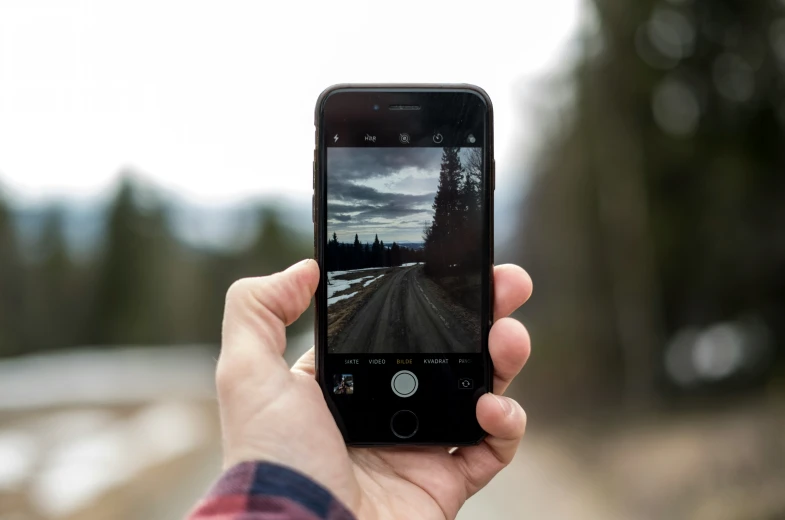 a person holds a phone with an image of the street