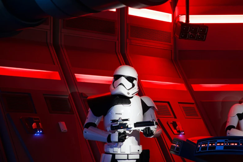 a white stormtrooper dressed in an armor with a camera in his hands