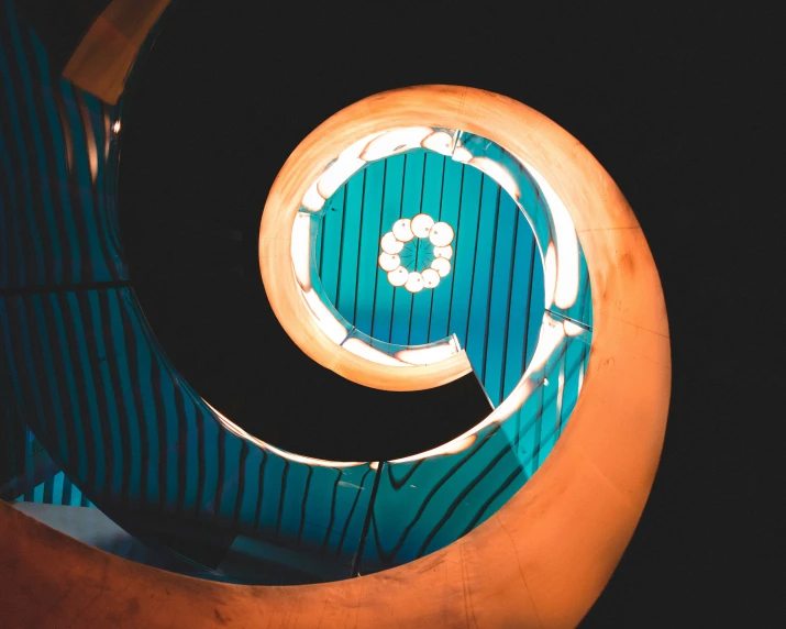 a neon light above a round green table