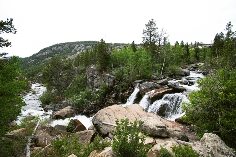 a rocky cliff with water cascading down it