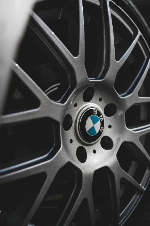 a black car wheel with a blue logo is shown