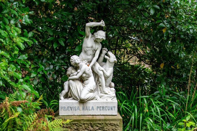 a statue of a group of women in a garden