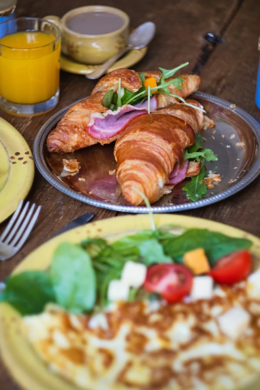 two plates with food on them are sitting on the table