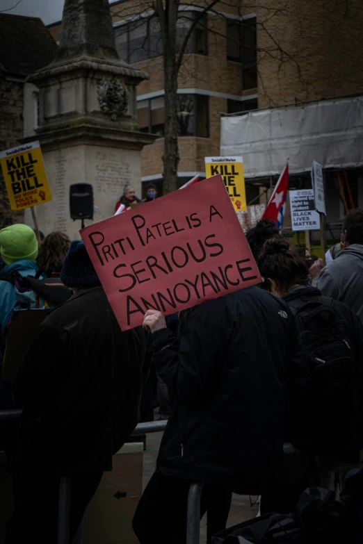 protestors hold signs at an outside protest rally