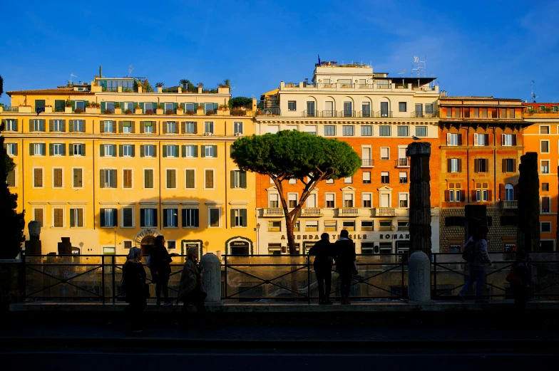 some people and buildings and a tree