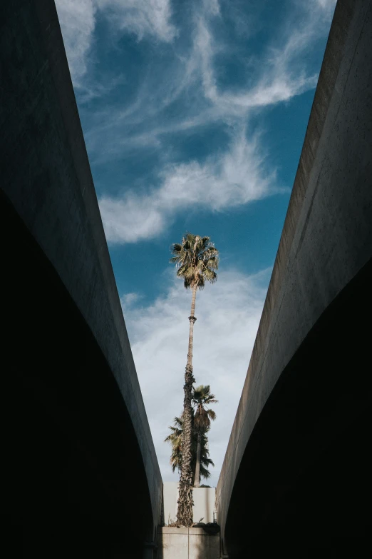 a tall tower sitting between two cement bridges