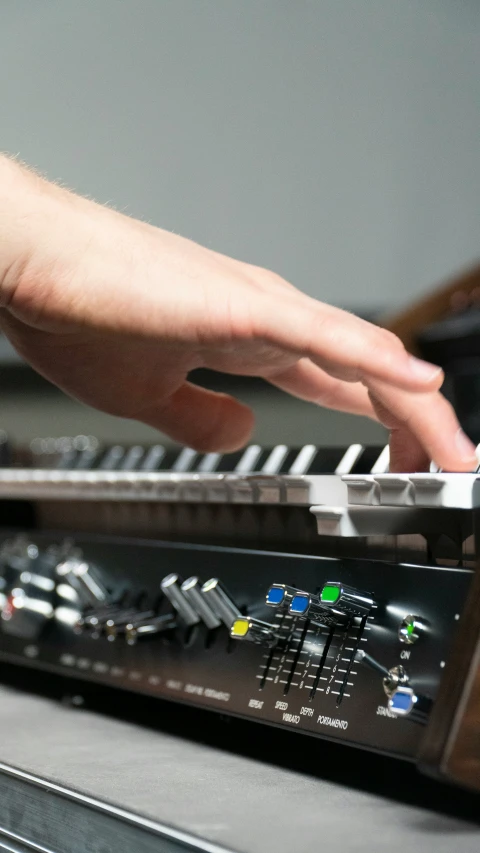 a person is using their hand to play the keyboard