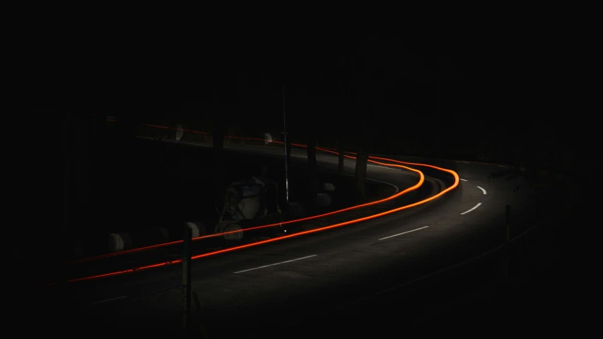 a couple of people on a street with long lights