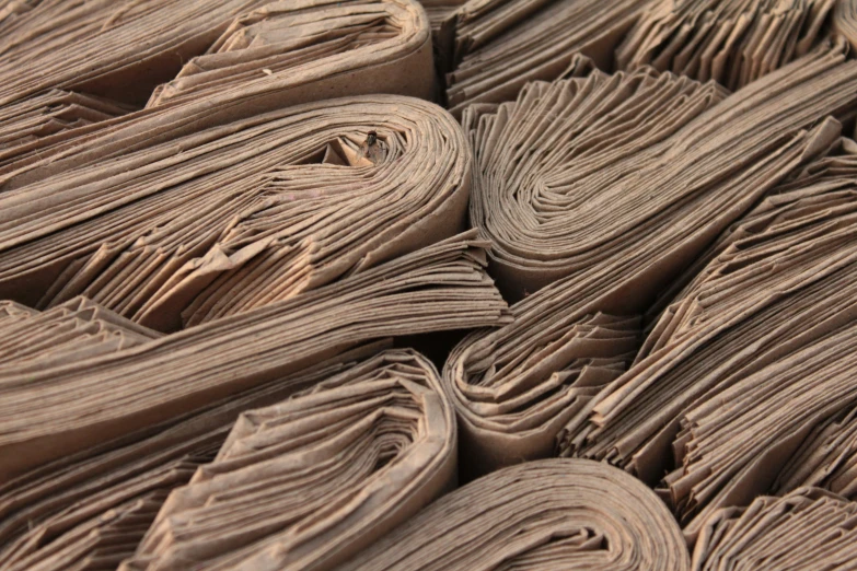 stacks of newspapers spread neatly on a table