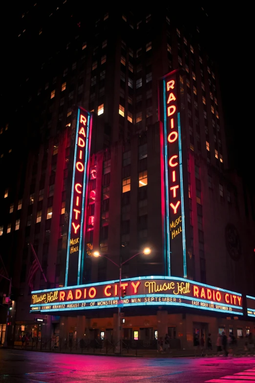 a night time view of an illuminated radio city radio city building