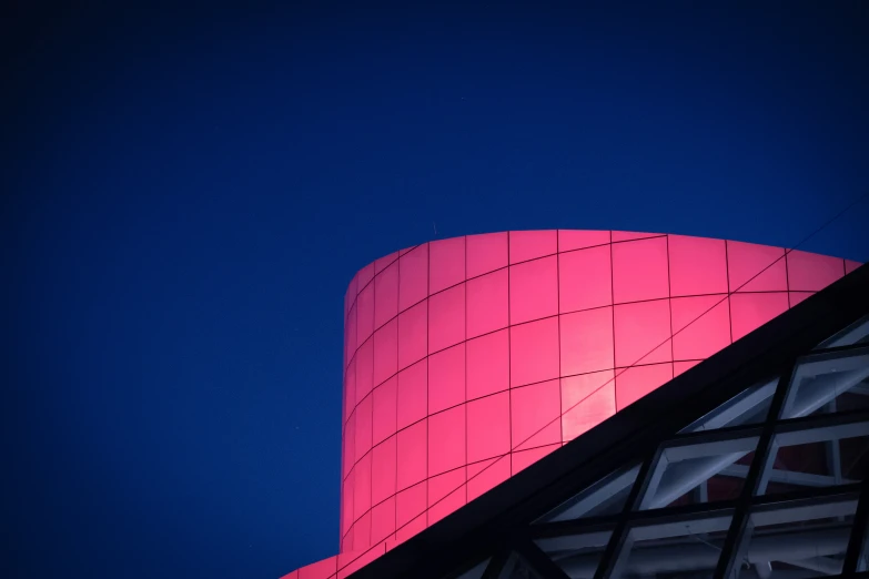 a pink object that is sitting on the side of a building