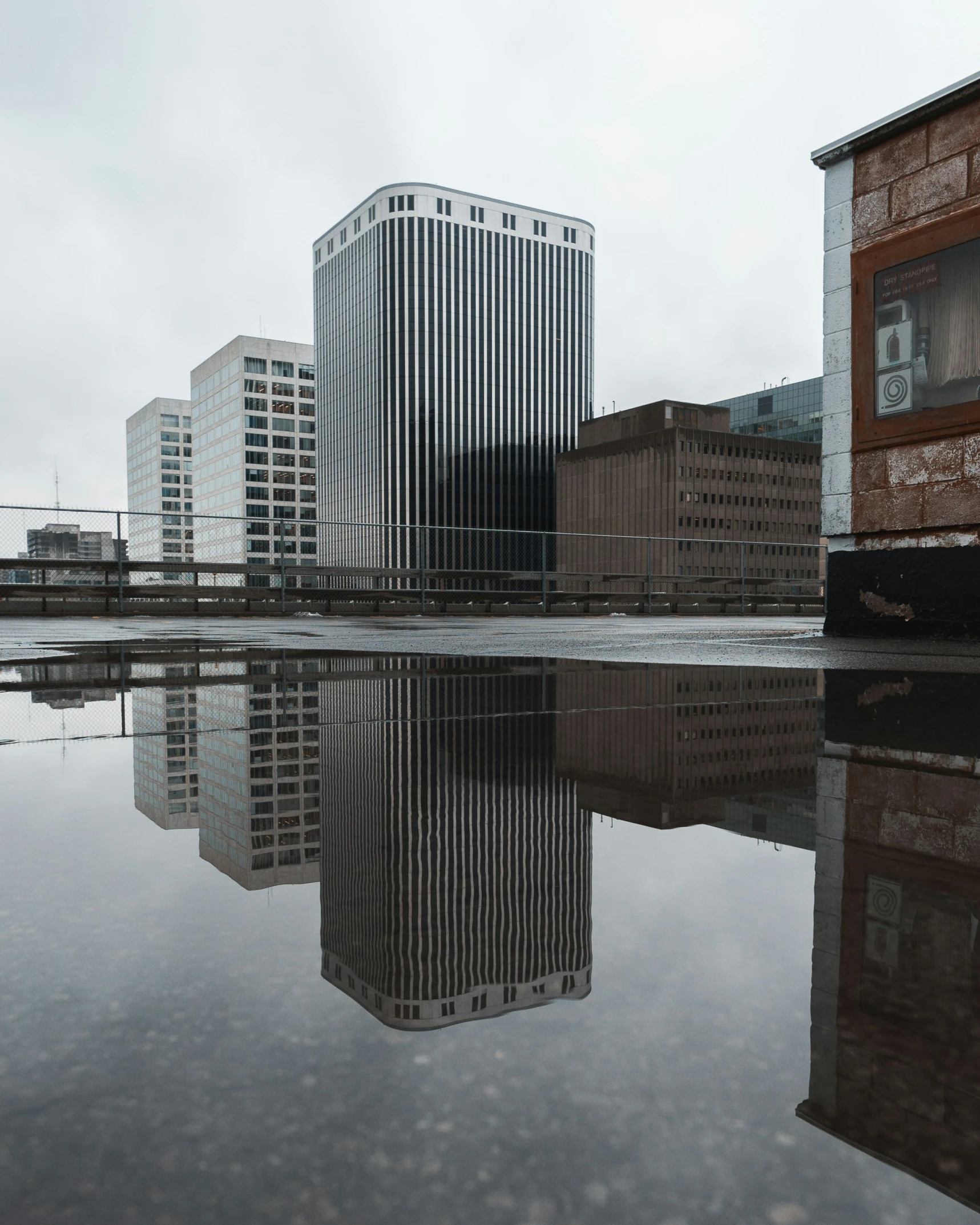 buildings are reflected in the water with one on each side