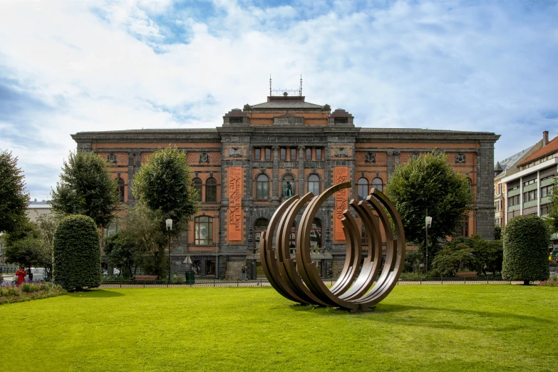 a sculpture sitting on top of a green field