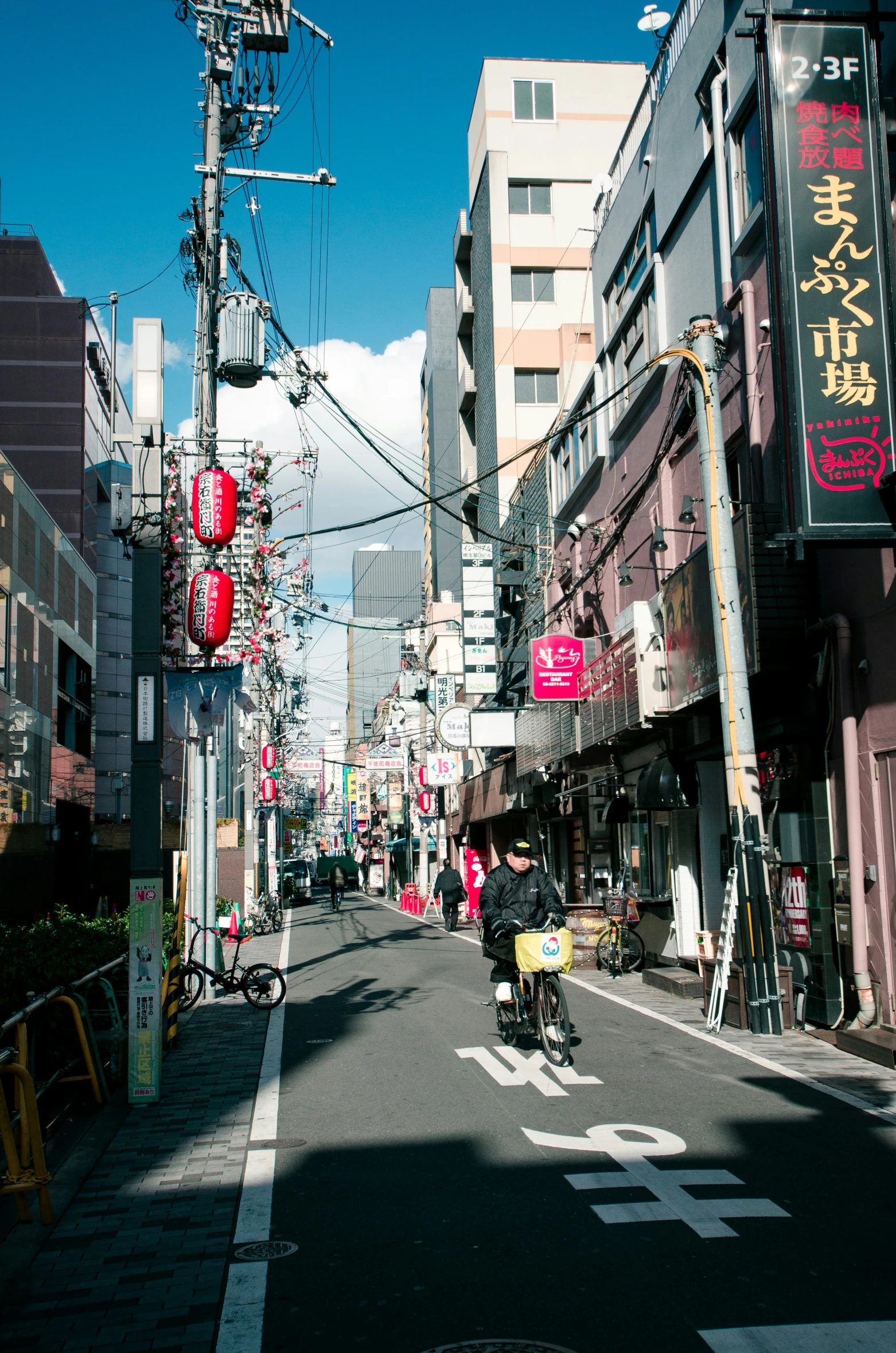 the empty street on which a man is riding his motorcycle