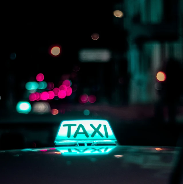 neon taxi light on the roof of a car