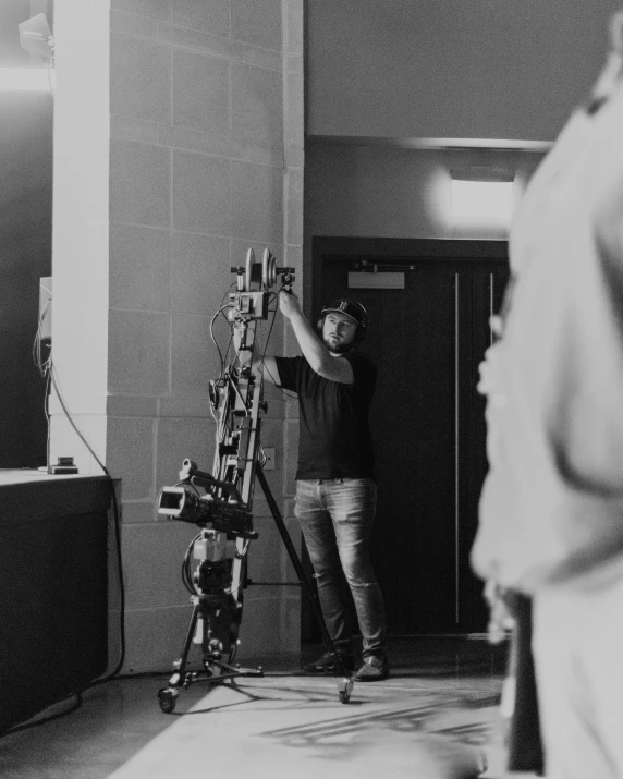 a man standing next to a wall in a room